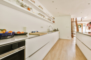 Kitchen with white cabinets and long countertop