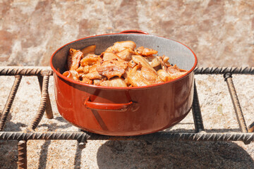 A pot filled with food sitting on top of a stove