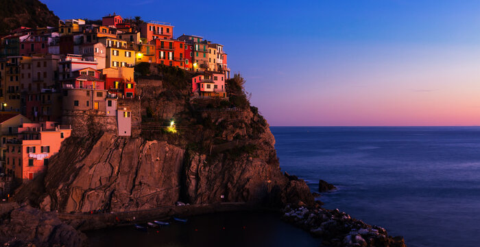 Image of view of Manarola city La Spezia at dusk on top of the hill, Italy