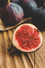 A few figs in a bowl on an old wooden background.