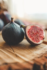 A few figs in a bowl on an old wooden background.