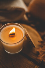 Burning candle in home interior, autumn aesthetics