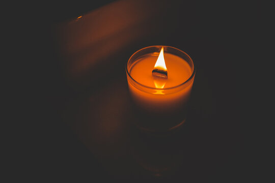 Burning candle in the dark close-up