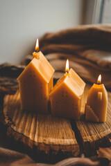 Handmade candles in the shape of a house in an autumn interior
