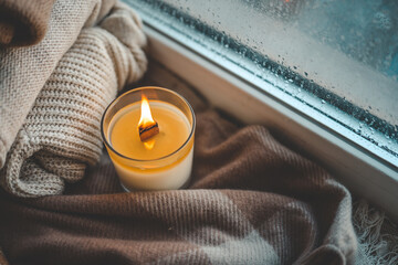 Burning candle in home interior, autumn aesthetics