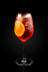 Spritz. This is a Venetian cocktail based on sparkling wine, served as an aperitif in northeastern Italy. It contains Prosecco, a bitter digestif. Drink in a glass on a dark background with reflection
