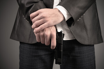 A man in a suit pointed a gun