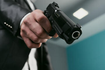 A man in a suit pointed a gun