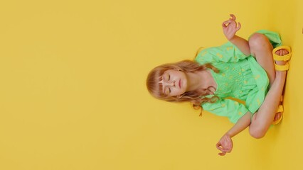 Keep calm down. Blonde child girl kid breathes deeply with mudra gesture, eyes closed, meditating with concentrated thoughts, peaceful mind, relaxing, taking a break, rest. Preteen children. Vertical - Powered by Adobe