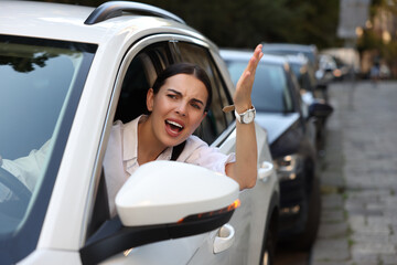 Angry driver screaming at someone from car in traffic jam - obrazy, fototapety, plakaty