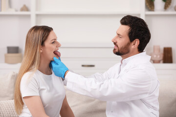 Obraz premium Doctor in gloves examining woman`s oral cavity indoors