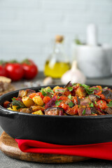 Dish with tasty ratatouille on grey textured table, closeup