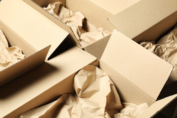 Open cardboard boxes with crumpled paper. Packaging goods