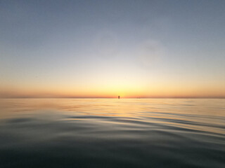 Sunrise on Lake Michigan with distant buoy