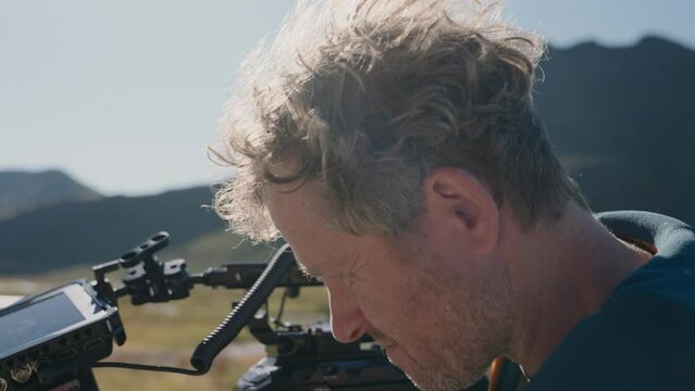 Filmmaker Reviewing Footage On Camera
