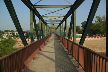 Fototapeta na wymiar Ancient iron bridge crossing the Pa Sak river in Middle of Thailand.