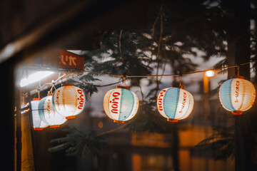 Okinawan beer lanterns are reflected on the glass