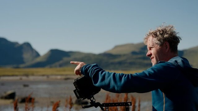Filmmaker With Camera Pointing His Finger