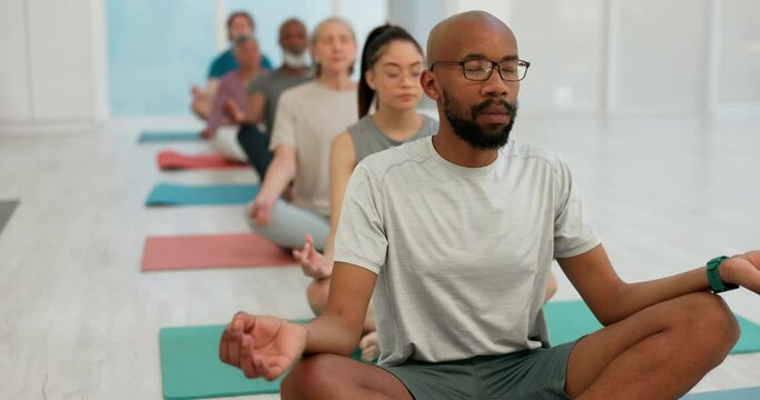 Meditation, yoga class and people in lotus pose at gym for fitness for peace, zen or mental health balance. Breathe, exercise or man guide with group for energy workout, wellness or holistic training