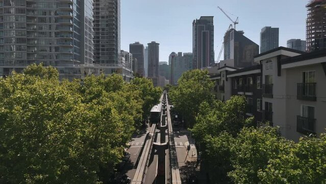 Aerial shot moving towards downtown Seattle with monorail moving away from downtown.