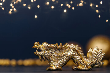 Golden dragon symbol of the year 2024 on a dark background