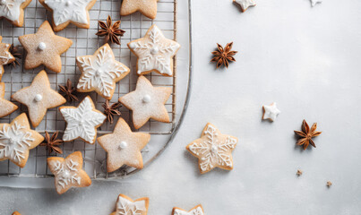 Fototapeta na wymiar Overhead view of christmas star shaped cookies being prepared in a festive kitchen
