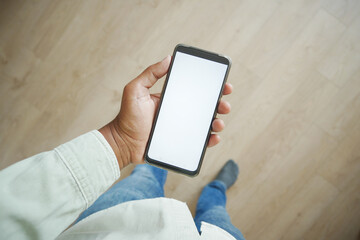 pov shot of young man hand using smart phone at home 
