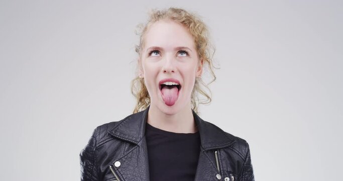 Goofy expression, face of woman in studio with funny and positive attitude for meme, post or comedy. Crazy emoji, silly performance and portrait of happy person with comic facial on white background.