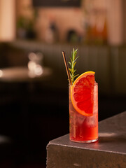 Freshly made spritz cocktail with blood orange and rosemary.