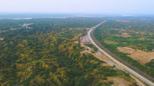 Aerial Drone shot of an empty railway track through semi arid forest valley of Chambal river in India