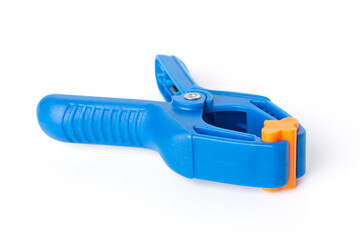 Blue plastic clamp on white background. Plastic clip, front view.