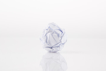 Close-up of crumpled ball of paper, on white background