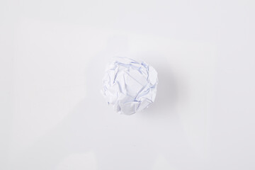 Close-up of crumpled ball of paper, on white background