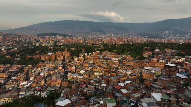 Aerial view over ghetto homes in Comuna 13, sunny evening in Medell&iacute;n, Colombia