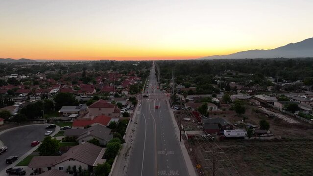 Bloomington California aerial fly down busy street at sunset AERIAL DOLLY