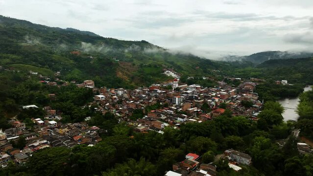 Aerial view circling around the San Rafael Town, in cloudy Antioquia, Colombia
