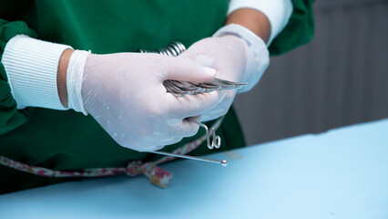 Man's hand in a white glove storing surgical equipment. Surgical instrument. Equipment used in surgery.