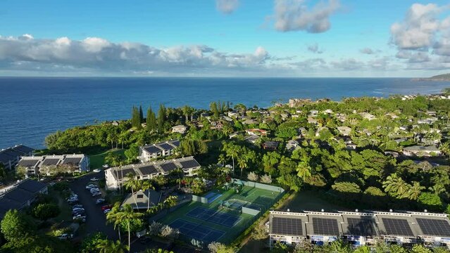 Aerial Princeville Kauai Hawaii resort condominium ocean 2. Expensive luxury homes, resort, condominium and golf club near coast. Green landscape. Hawaiian Island. Garden Isle. Economy tourism based.