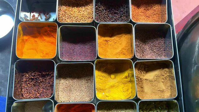 A variety of Indian spices set in a stainless steel box