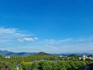 
It is a park with blue sky and forests.