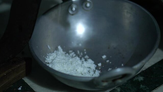 close up video clip of coconut grating manually by hand in home of India