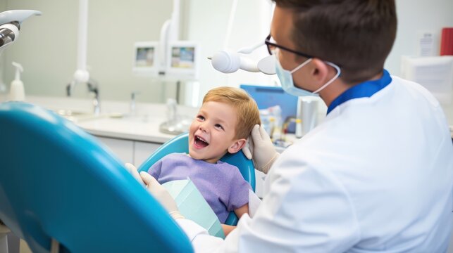 Little boy getting his teeth checked by dentist at dental clinic.