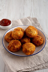 Homemade Cheesy Chicken Nuggets with Ketchup, side view. Copy space.