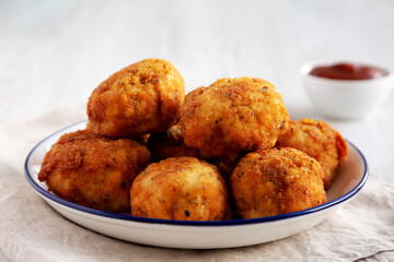 Homemade Cheesy Chicken Nuggets with Ketchup, side view.