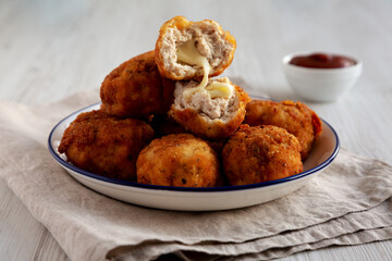 Homemade Cheesy Chicken Nuggets with Ketchup, side view.