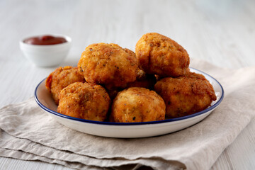 Homemade Cheesy Chicken Nuggets with Ketchup, side view.