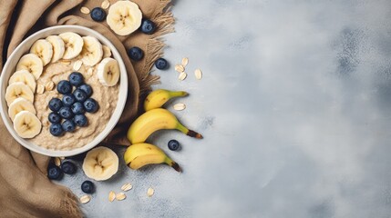 Healthy oatmeal with fruits and nuts for breakfast or lunch presented on a napkin and cement background