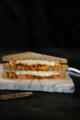 Chicken Tikka Mint Grilled Sandwich isolated on wooden board side view of fast food on dark background