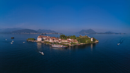 Naklejka na ściany i meble Lake Maggiore, island, Isola Bella, Italy. Panorama at sunset on Lake Maggiore top view. Aerial drone view of Isola Bella drone panoramic view. Borromean Islands, Lake Maggiore, Piedmont, Europe.