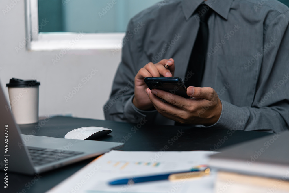 Poster man using mobile smartphone working and digital online computer laptop at office